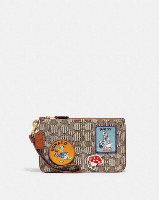 DISNEY X COACH SMALL WRISTLET IN SIGNATURE TEXTILE JACQUARD WITH PATCHES